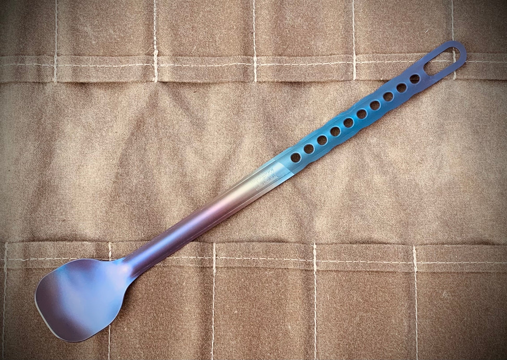 Marten Long Titanium Spoon with a light purplish heat anodized colorway