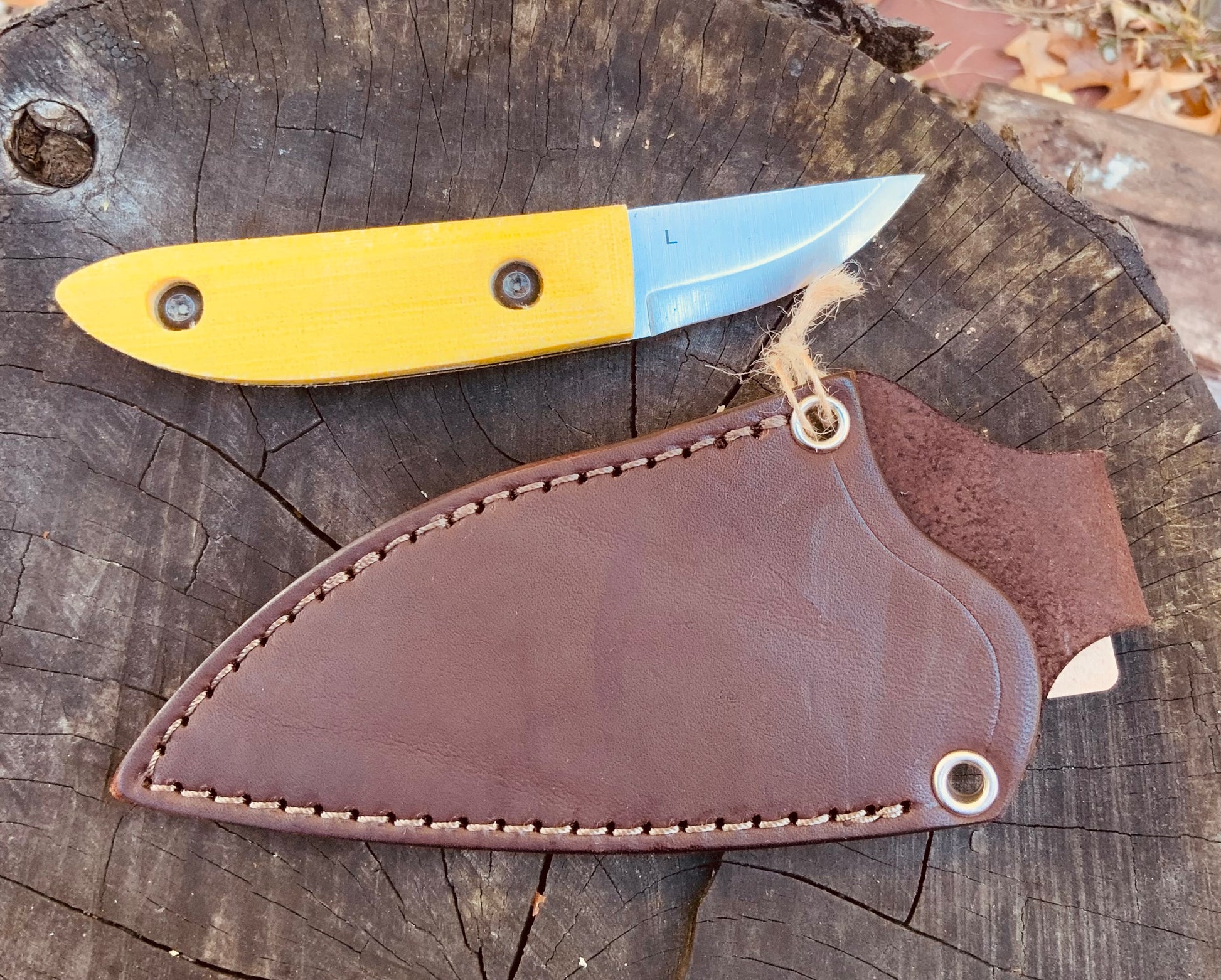 Kerf Carver Knife with Yellow Terotuf scales and leather JRE sheath from Woods Monkey