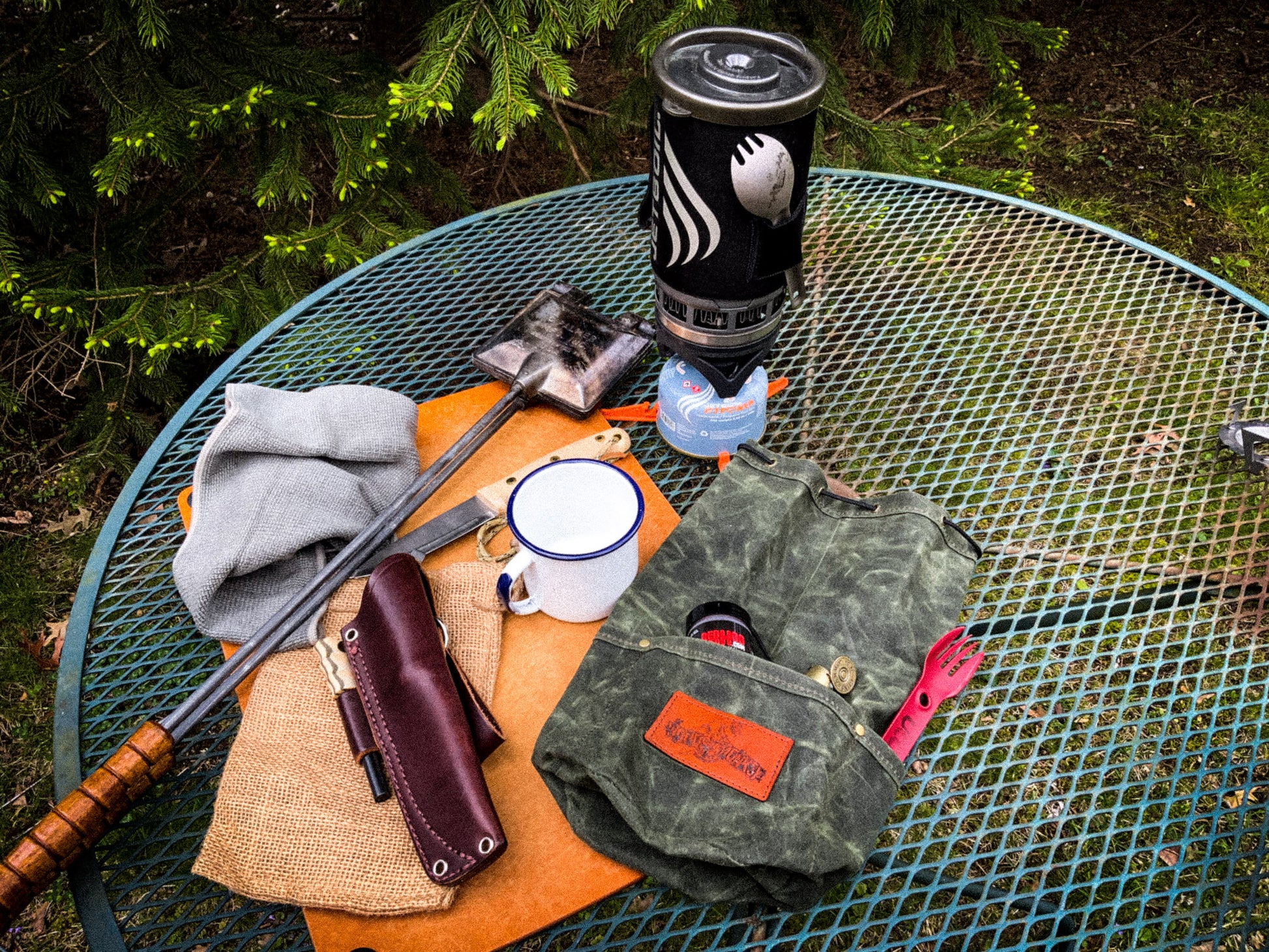 Bushcraft waxed bag with items that fit inside of it
