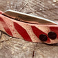Banana Peel Folder, folding knife shown with red twist micarta scale handles