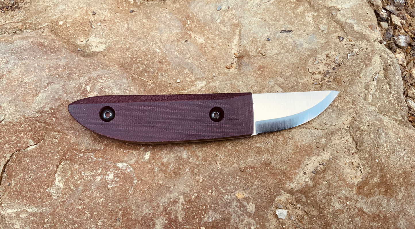 Kerf Carving Knife by Woods Monkey shown with Double Red Micarta Scales