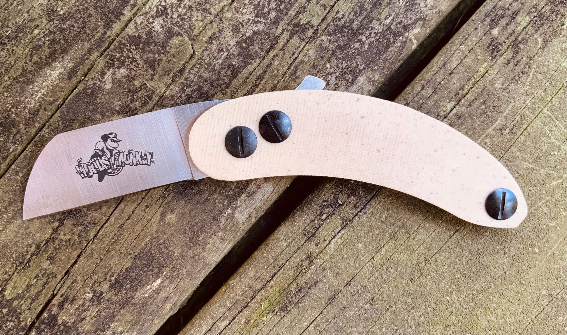 Woods Monkey Banana Peel Neck Knife shown in snakeskin micarta