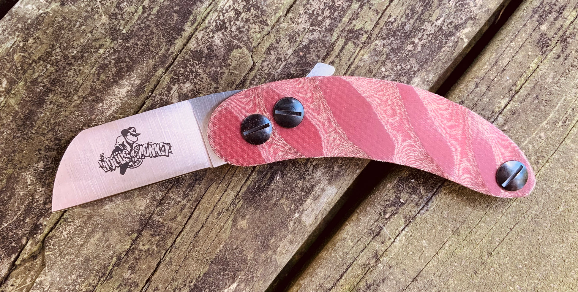 Banana Peel Neck Knife shown with red micarta scales and sheepsfoot blade shape