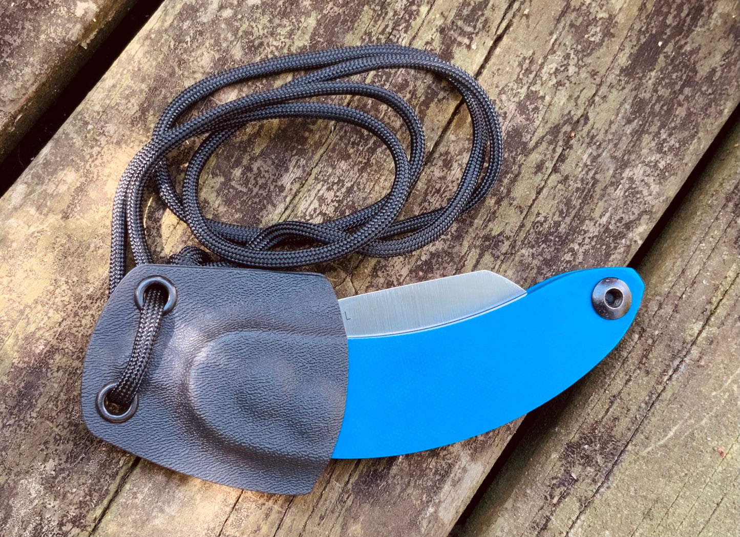 Banana Peel Folder and Custom Neck Sheath Combo shown in blue G10, folding inside of the kydex neck sheath